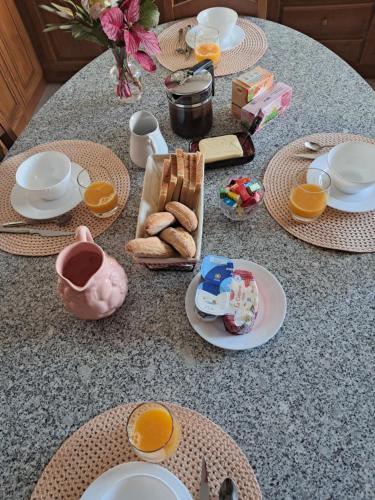 a table with plates and cups and food on it at Casa dos Encantos in Arcos de Valdevez