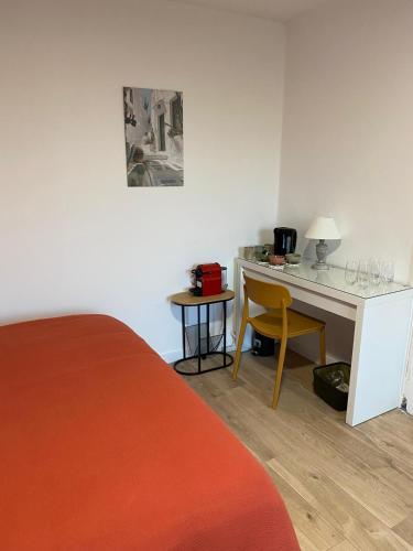 - une chambre avec un bureau, un lit et une table dans l'établissement Chambre familiale indépendante avec salle de bain privée, à Poitiers