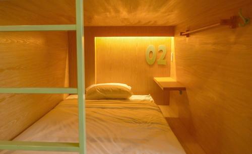 a bedroom with a bunk bed in a room at Leaf Sustainable Hostel in Da Nang
