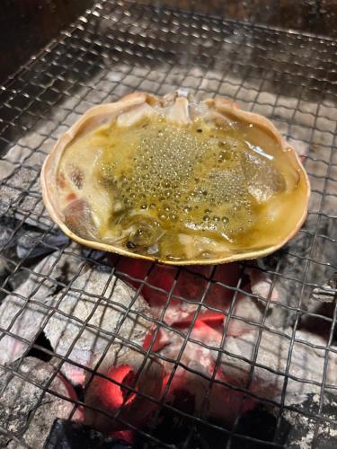 a pancake is cooking on a grill at Pension Kurumi no Ki in Toyooka