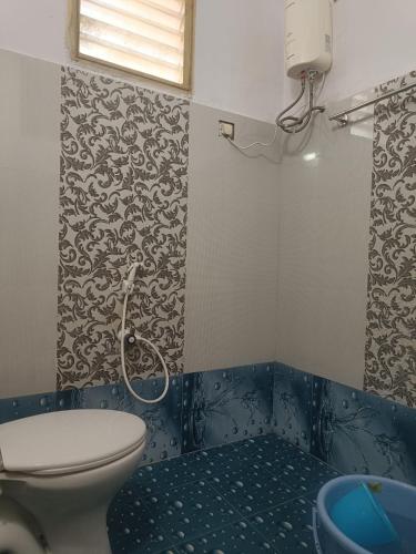 a bathroom with a toilet and a sink at Rest N' Refresh Homes in Visakhapatnam
