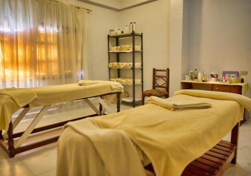 a hospital room with two beds and a window at Tropitel Dahab Oasis in Dahab