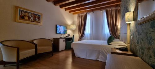 a hotel room with a bed and a window at UNAHOTELS Eco Hotel Villa Costanza Venezia in Mestre