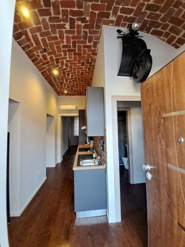 a kitchen with a brick ceiling and a sink at Frabosa Loft in Turin