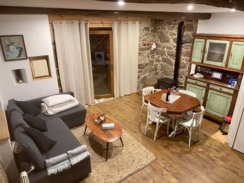 a living room with a couch and a table at Lagar de Guxeva in Chantada