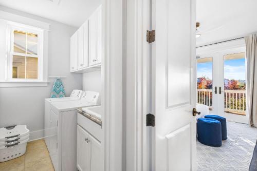 a white bathroom with a sink and a toilet at Saffron Sands by Stay on 30A- Pool, Bikes, Golf Cart in Seagrove Beach