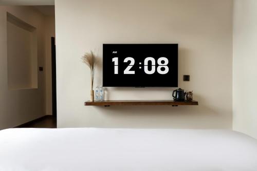 a television on a shelf in a white wall at The Whisperer Guanshan Private Residence Hotel in Dali