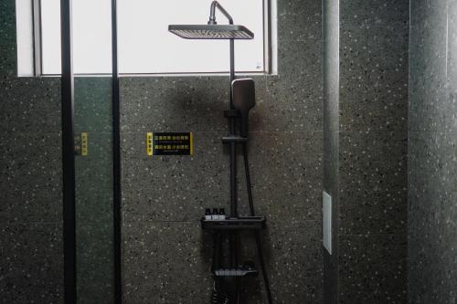 a glass door with a sign on the side of a building at The Whisperer Guanshan Private Residence Hotel in Dali