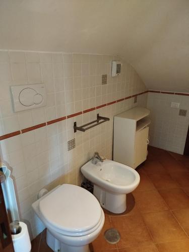 a small bathroom with a toilet and a sink at La Casa di Pietra in Fonte Nuova
