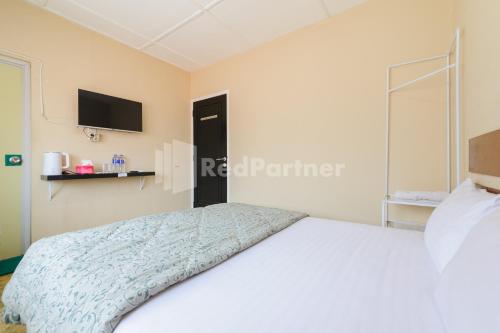 Кровать или кровати в номере Arwana Inn Lampung Mitra RedDoorz