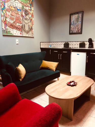 a living room with a couch and a coffee table at Au bout du pré in Pézenas
