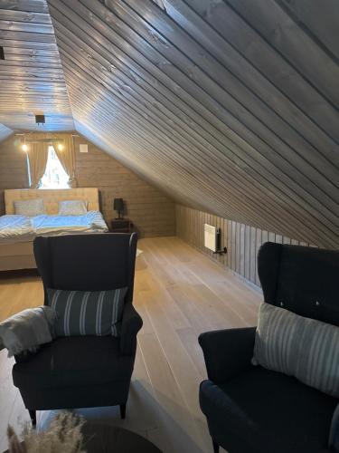 a attic bedroom with a bed and a couch at Idre himmelfjäll ski in out in Idrefjäll