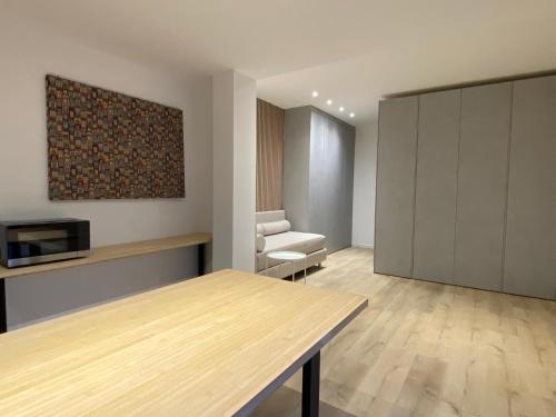 a living room with a table and a couch at Aiace-diana alle terme euganee&y40 in Montegrotto Terme