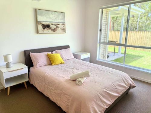 a bedroom with a large bed with a window at Brand New Home - Spacious Family Retreat in Park Ridge