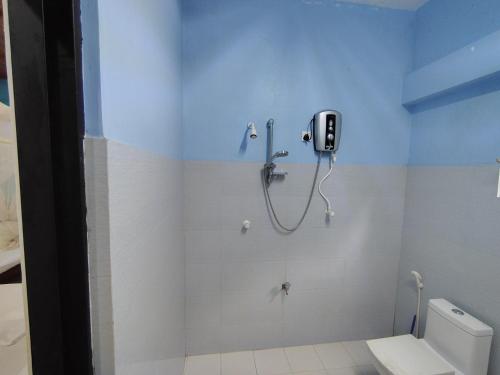 a shower stall in a bathroom with a toilet at Bungalow Resort - Sigiriya in Sigiriya