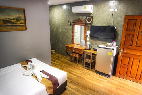 Postel nebo postele na pokoji v ubytování Huen San Fang hotel โรงแรมเฮือนแสนฝาง