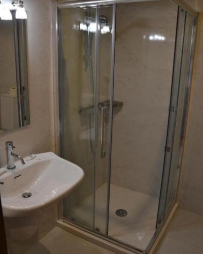 a bathroom with a shower and a sink at Hotel Santo Andre in Póvoa de Varzim