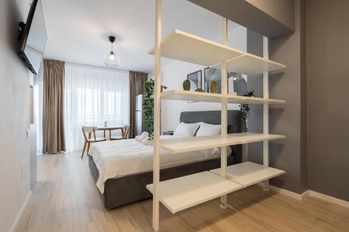 a bedroom with a bed and a book shelf at Springview Studio in Bucharest