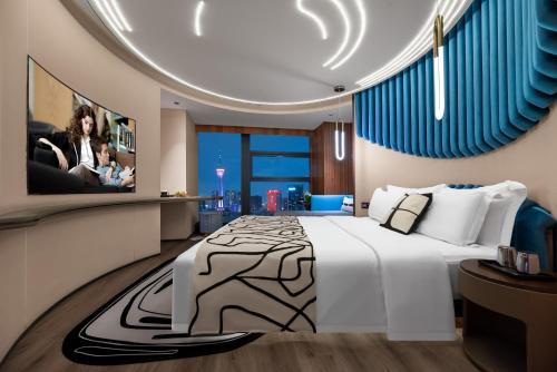 a bedroom with a large bed and a tv at Beso Designer Apartent Hotel in Chengdu