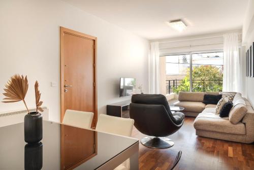 a living room with a couch and a chair at Phaedrus Living Evergreen Nicosia City Residence in Nicosia