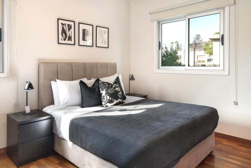 a bedroom with a large bed and a window at Phaedrus Living Evergreen Nicosia City Residence in Nicosia