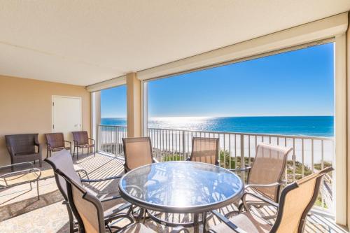 a balcony with a table and chairs and the ocean at Bluewater 402 in Orange Beach