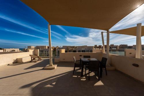 a patio with a table and chairs on a roof at El Gouna - BIRD NEST in Hurghada