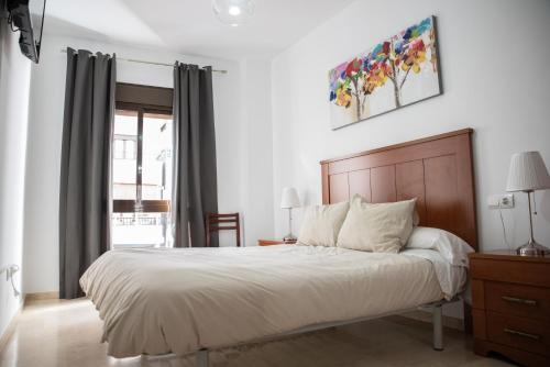 A bed or beds in a room at Apartamento Atenea centro con garaje gratuito