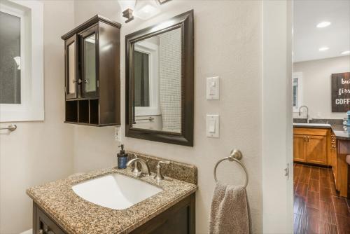 a bathroom with a sink and a mirror at Phillips Lake Lodge in Shelton