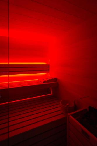 a red room with a bench and a red light at Zambala Luxury Apartments in Milan