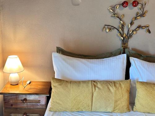a bedroom with a bed with a table with a lamp at Pandoras House Arachova in Arachova