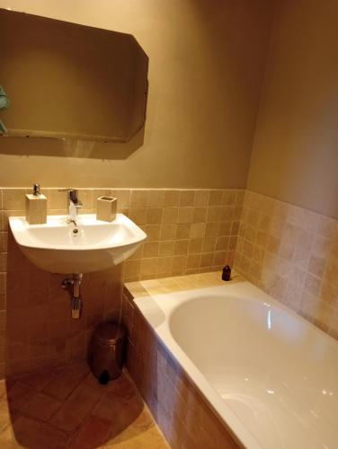a bathroom with a sink and a bath tub at Villa Mogrovejo in Mogrovejo