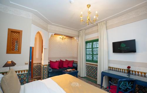 a hotel room with a bed and a couch at Palais Faraj Suites & Spa in Fès