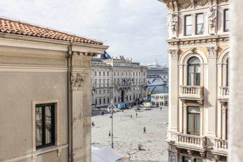 a view of a city street from between two buildings at Piazza Unità House in Trieste