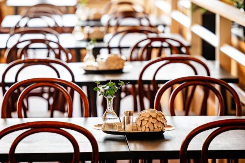 a row of tables and chairs with a plate of food at Hotel Lysekil in Lysekil