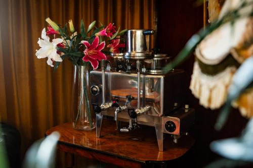 a vase of flowers on a table with a vase of flowers at Hotel Lysekil in Lysekil