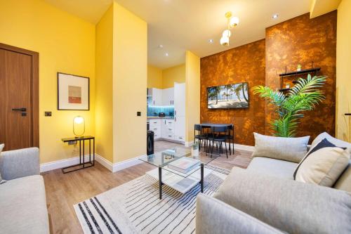 a living room with a couch and a table at Grand Central Station 2 Bed Apartment A1 in Glasgow