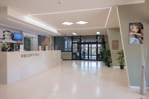 a lobby of a hospital with a reception desk at JR Hotels Gate 7 Bologna in Calderara di Reno