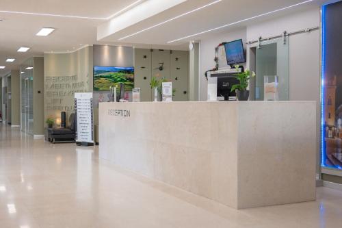a lobby of a hospital with a reception counter at JR Hotels Gate 7 Bologna in Calderara di Reno