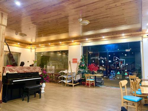 a store with a piano in a room with chairs at Pea Hostel in Sa Pa