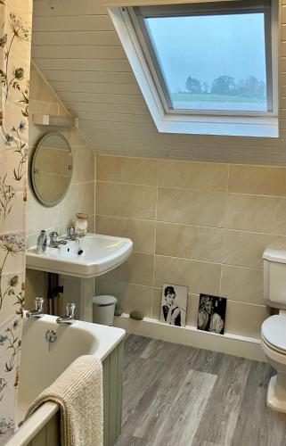 a bathroom with a sink toilet and a window at Elyvale Cottage in the heart of Rothbury in Rothbury