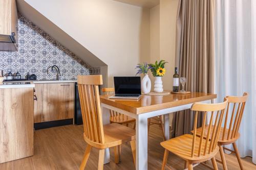 a kitchen with a table with a laptop on it at Doce Dioses , By IdealStay Experience in Lygaria