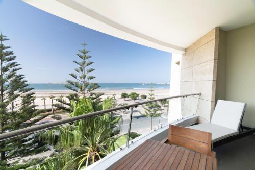 a balcony with a view of the beach at Atlas Essaouira Riad Resort in Essaouira