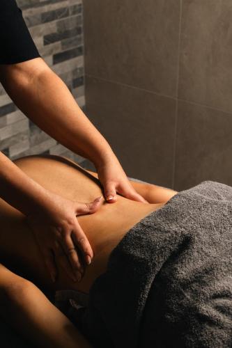 a woman getting a massage on her stomach at Caramela Luxury Apts in Ayia Napa