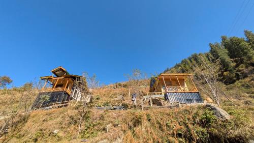 two houses on top of a hill at Monkstel Cottages Shangarh in Shangarh
