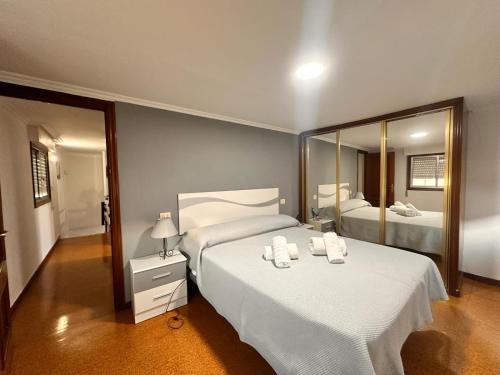 a bedroom with two beds and a large mirror at Casa Independiente en Quintela - HomeyGalicia in Vigo