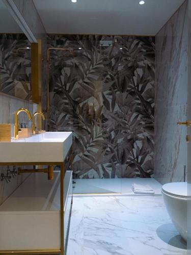 a bathroom with a sink and a toilet at Cappuccina Country Resort in San Gimignano