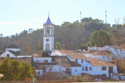 eine Stadt mit einem Uhrturm im Hintergrund in der Unterkunft La Casa de la Tierra by SIERRA VIVA in Los Marines