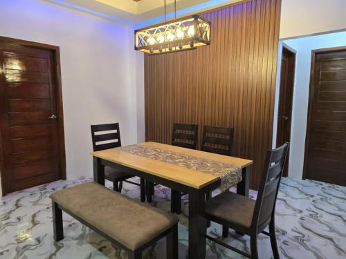 a dining room with a wooden table and chairs at Villa Luminous Private Resort in Upi