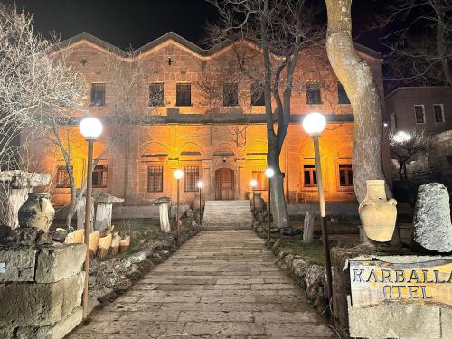 an old building with a stone pathway in front of it at Karballa Hotel in Aksaray